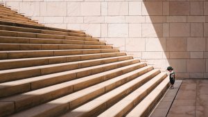 Picture of a small child at the bottom of a large set of stairs